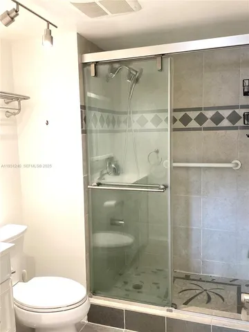 a white toilet next to a bathroom sink