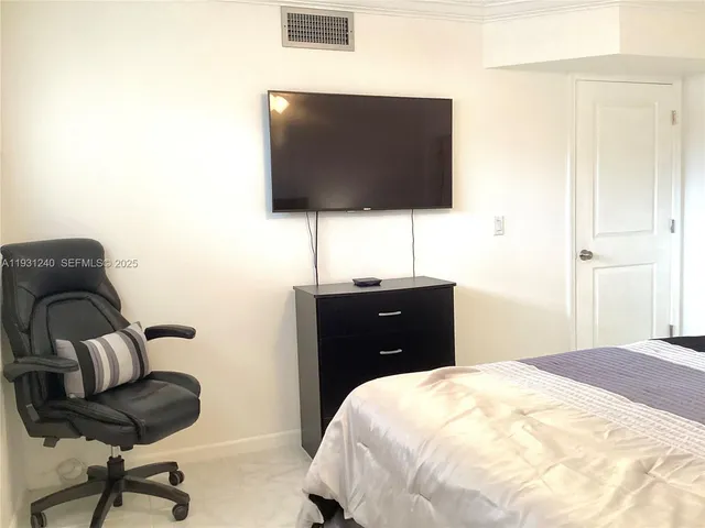 a bedroom with a bed and a chair