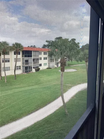 a view of a garden with a building in the background
