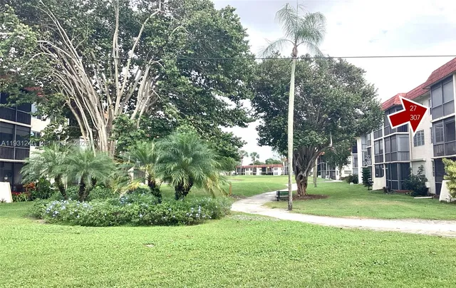 a view of a park with large trees