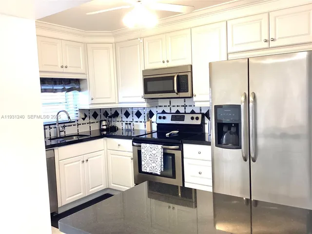 a kitchen with stainless steel appliances a refrigerator stove microwave and cabinets
