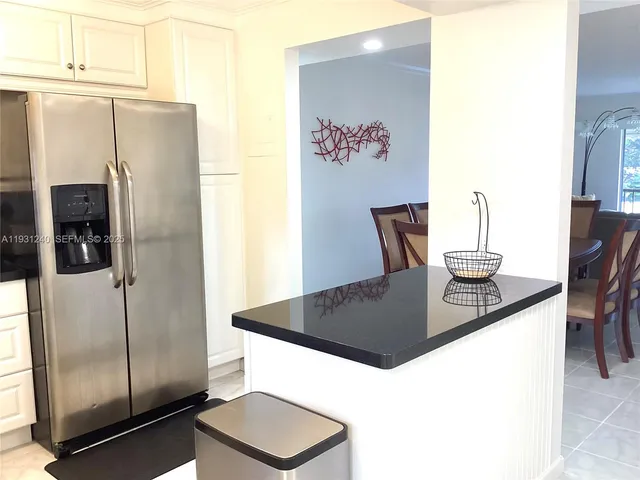a kitchen with a refrigerator and a sink