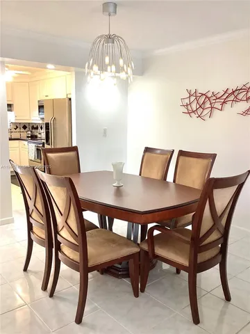 a view of a dining room with furniture and chandelier