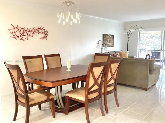 a view of a dining room with furniture and window