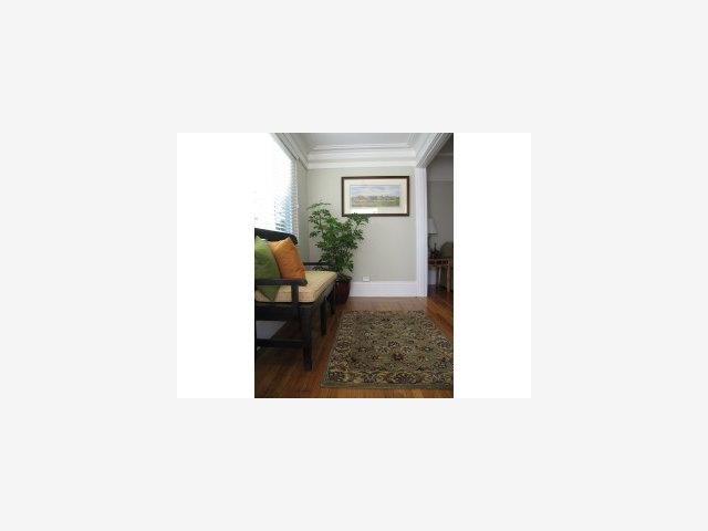 18 Victoria Road Burlingame, CA 94010 - Photo 2 of 9 a living room with a chair and potted plant