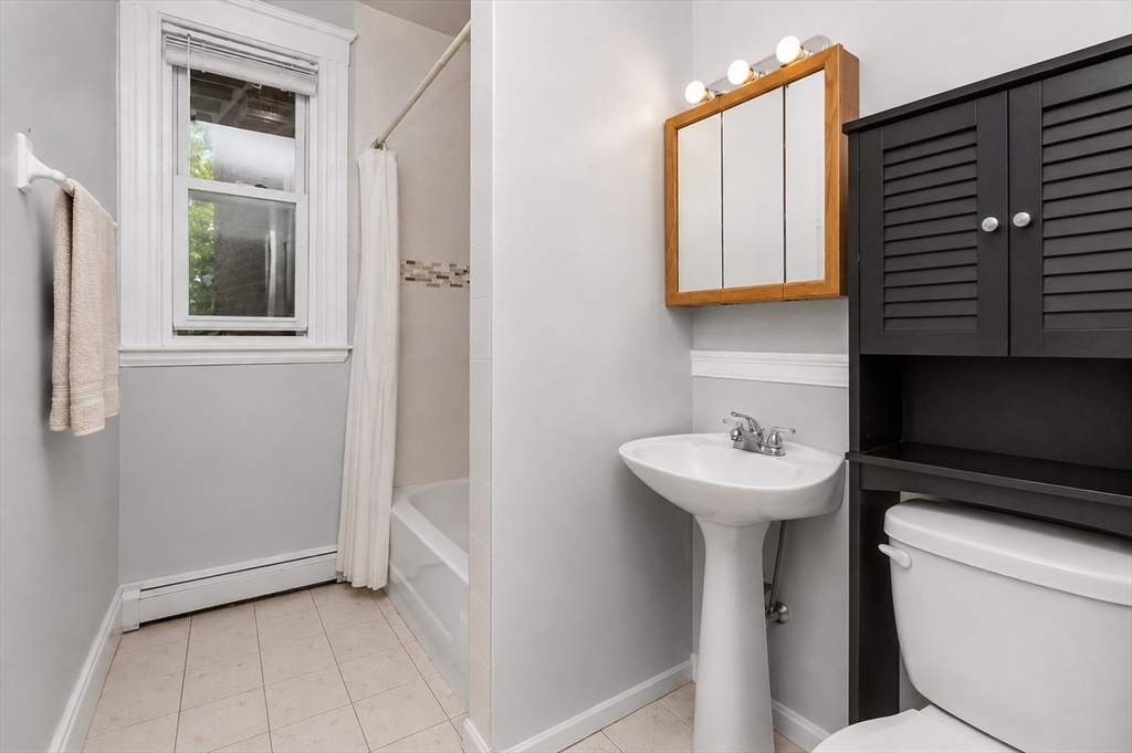 8 Colliston Road Boston, MA 02135 - Photo 20 of 40 a bathroom with a sink a toilet and a mirror