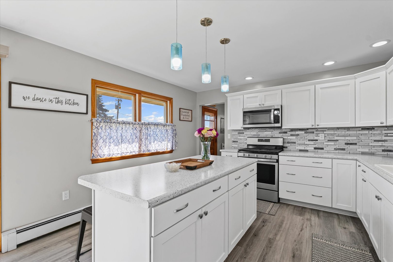 209 West Main Street Royal, IL 61871 - Photo 12 of 32 a kitchen with granite countertop stainless steel appliances a stove sink and microwave