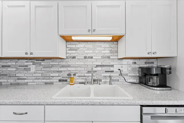 a kitchen with a sink and cabinets