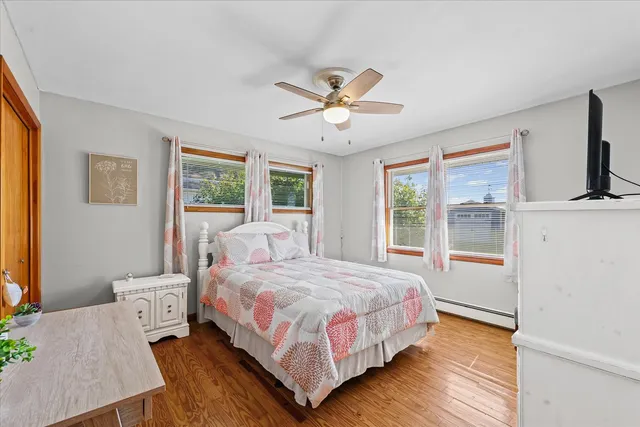 a bedroom with a bed lamp and a large window