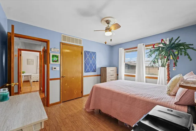 a bedroom with a bed and a chandelier