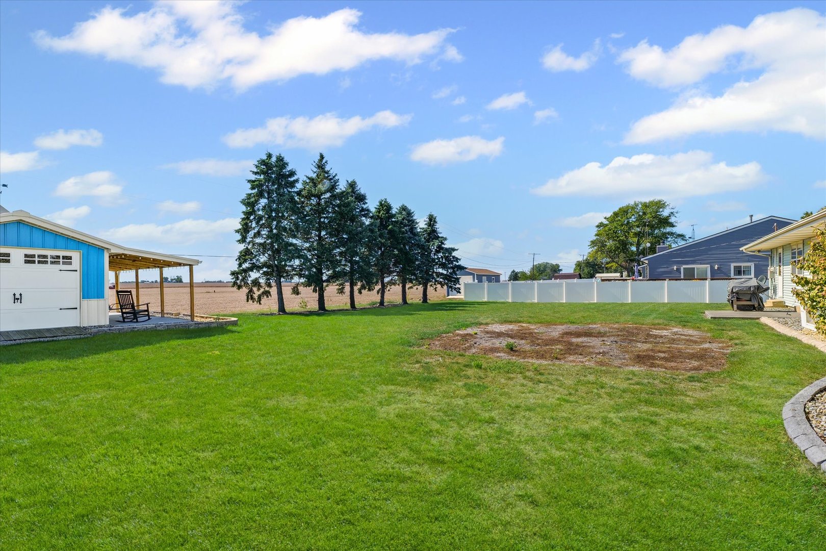 209 West Main Street Royal, IL 61871 - Photo 29 of 32 a view of a house with a big yard and a large tree