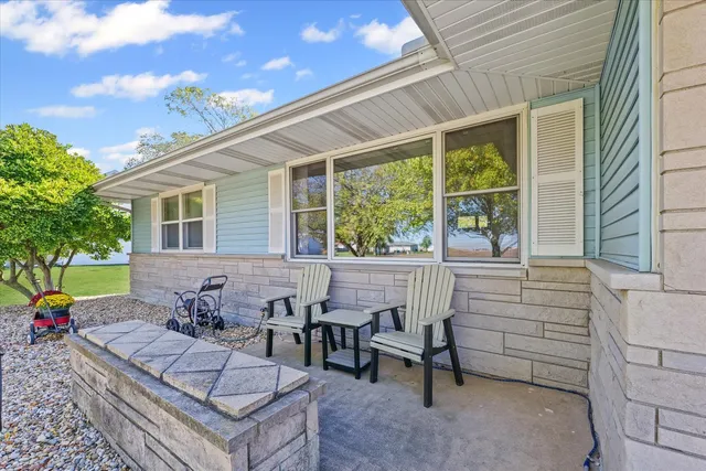 a view of a patio with table and chairs and potted plants