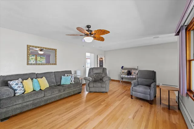 a living room with furniture and wooden floor
