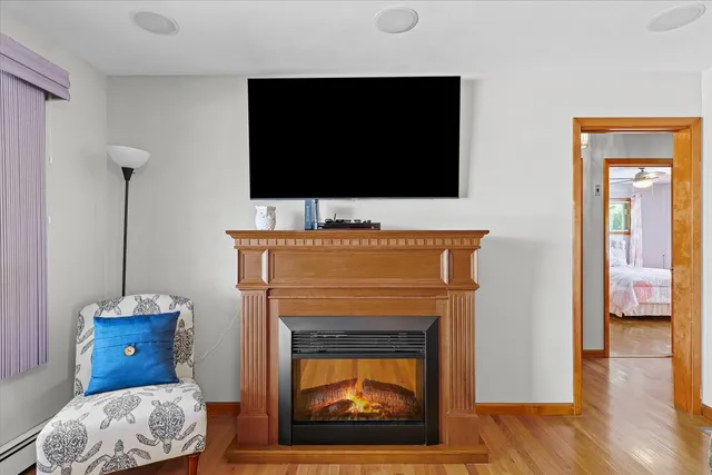 a living room with a fireplace and a flat screen tv