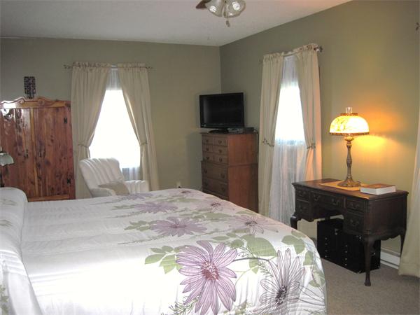 981 Tinkham Road Wilbraham, MA 01095 - Photo 11 of 21 a bedroom with a bed and a chandelier