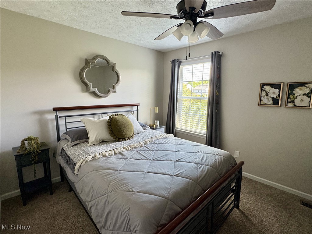 4156 Whitestone Road Kent, OH 44240 - Photo 23 of 28 Carpeted bedroom featuring a textured ceiling, baseboards, and ceiling fan