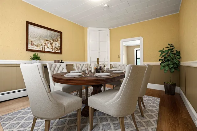 a view of a dining room with furniture and wooden floor