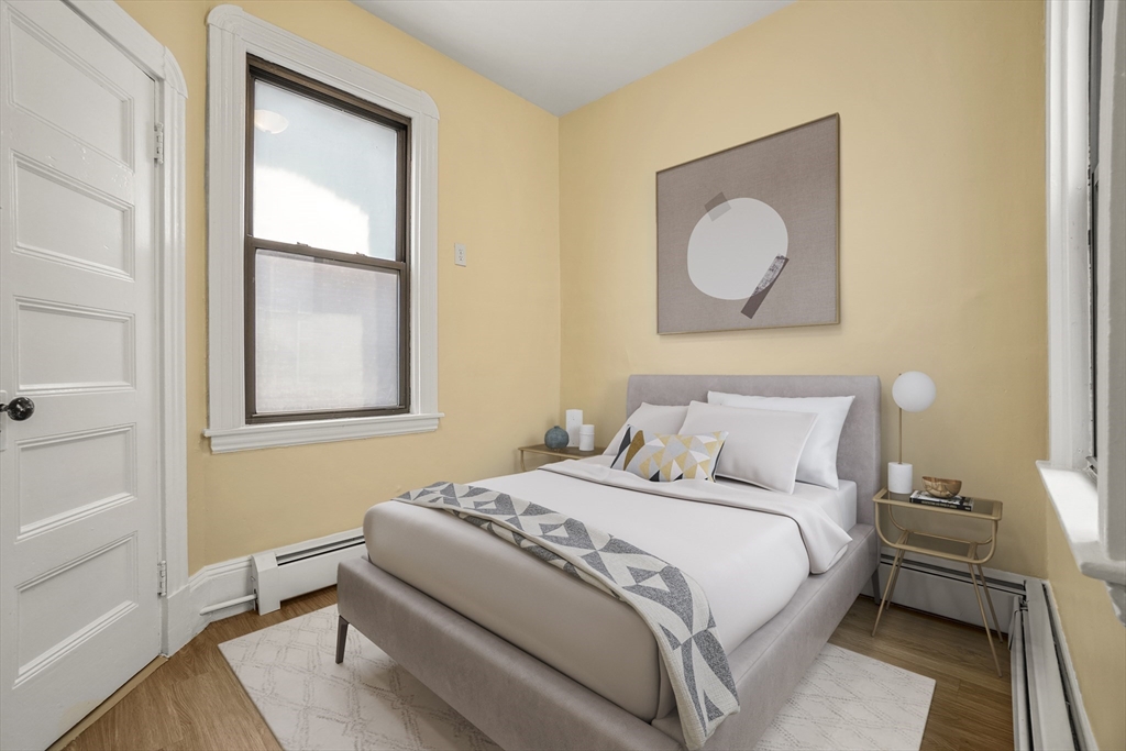58 Charles Street South, Unit 2 Boston, MA 02116 - Photo 5 of 9 a bedroom with a bed and a window
