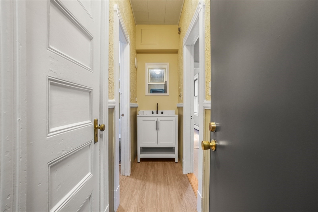58 Charles Street South, Unit 2 Boston, MA 02116 - Photo 7 of 9 a view of a bathroom from a hallway