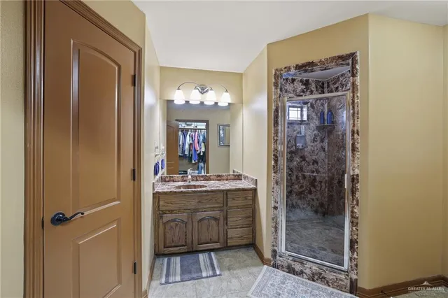 a bathroom with a mirror a sink and a shower