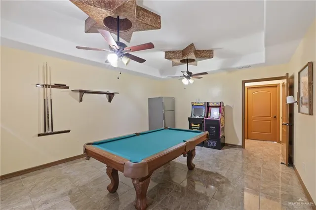 a room with pool table and wooden floor