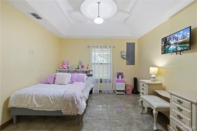 a bedroom with a bed and a chandelier