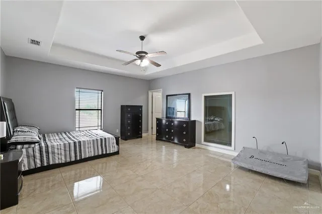 a spacious bedroom with two beds and a chandelier