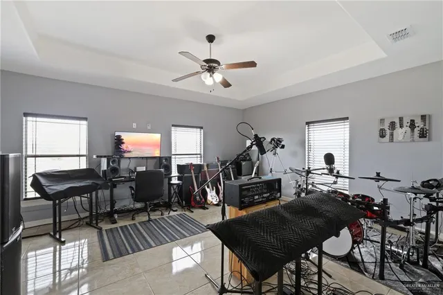 a living room with furniture a flat screen tv and a window