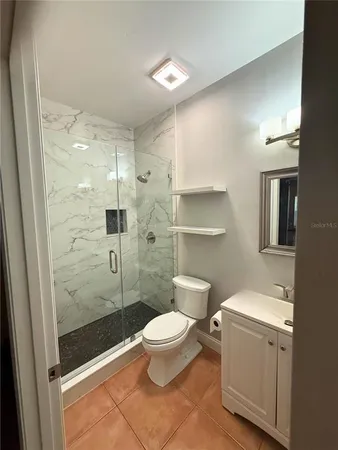 a bathroom with a toilet a sink and shower