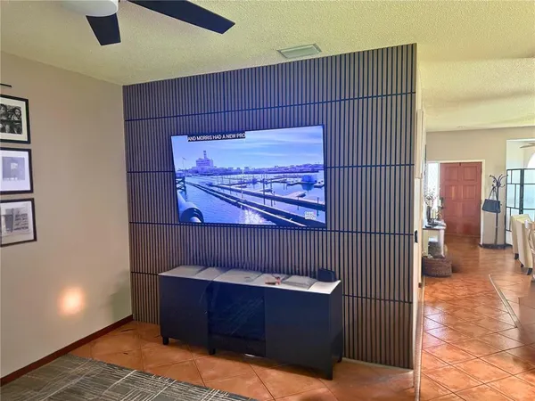a view of a hallway with a couch and chandelier