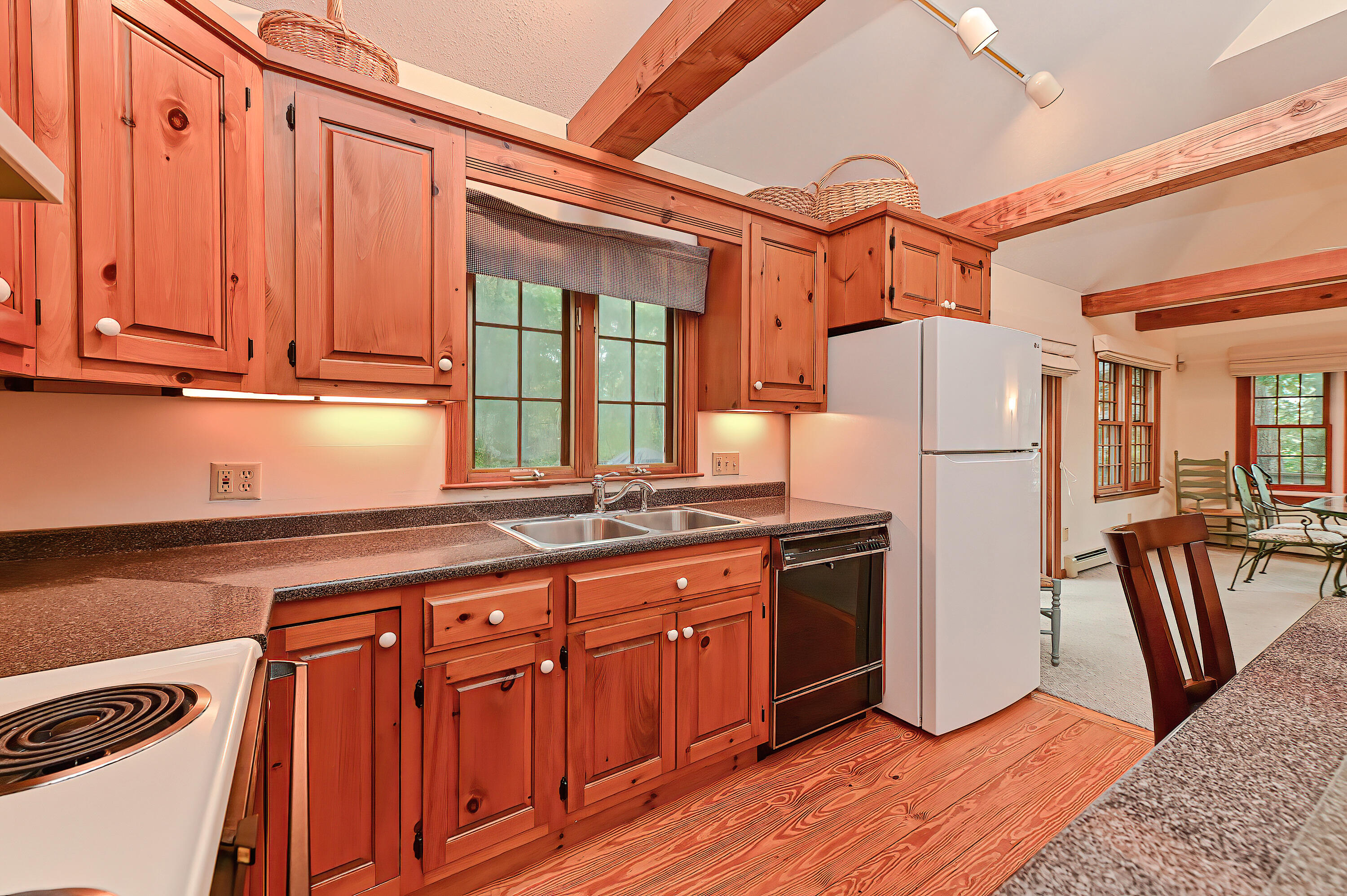 60 Grove Road Eastham, MA 02642 - Photo 12 of 39 a kitchen with stainless steel appliances granite countertop a refrigerator a stove a sink and dishwasher with wooden floor