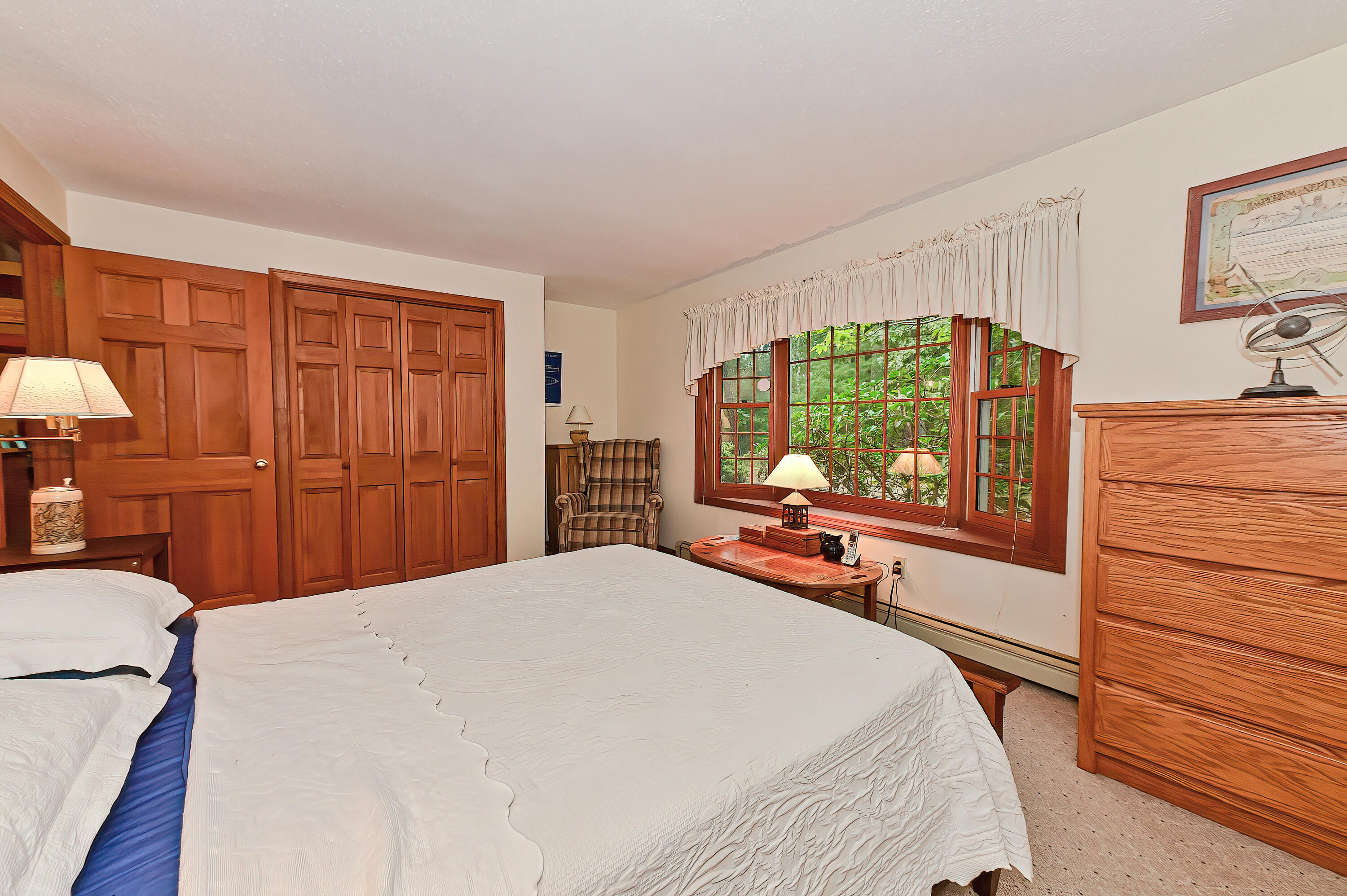 60 Grove Road Eastham, MA 02642 - Photo 18 of 39 a bedroom with a bed and a flat tv screen on dresser