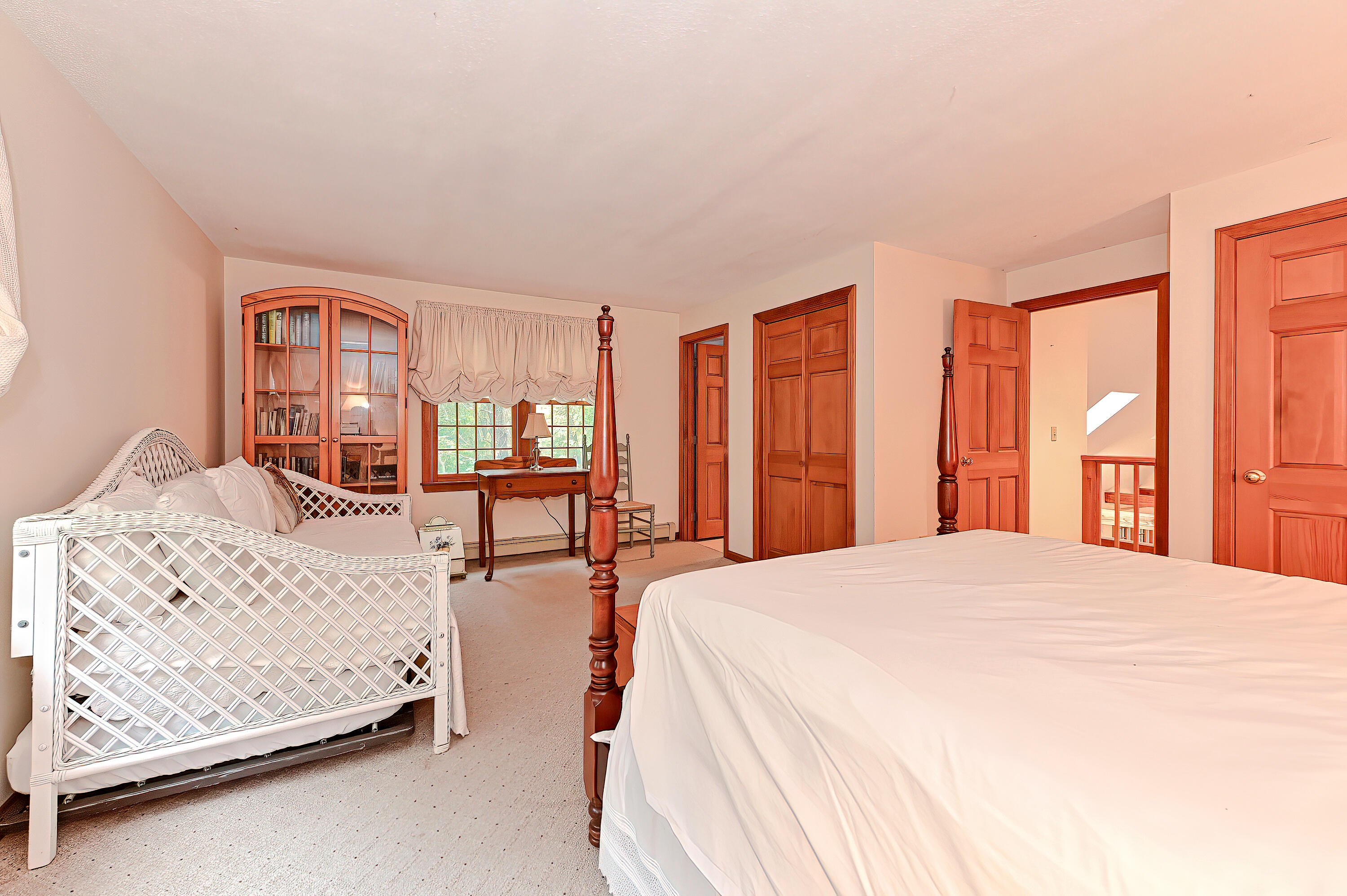 60 Grove Road Eastham, MA 02642 - Photo 25 of 39 a spacious bedroom with a bed and a large window