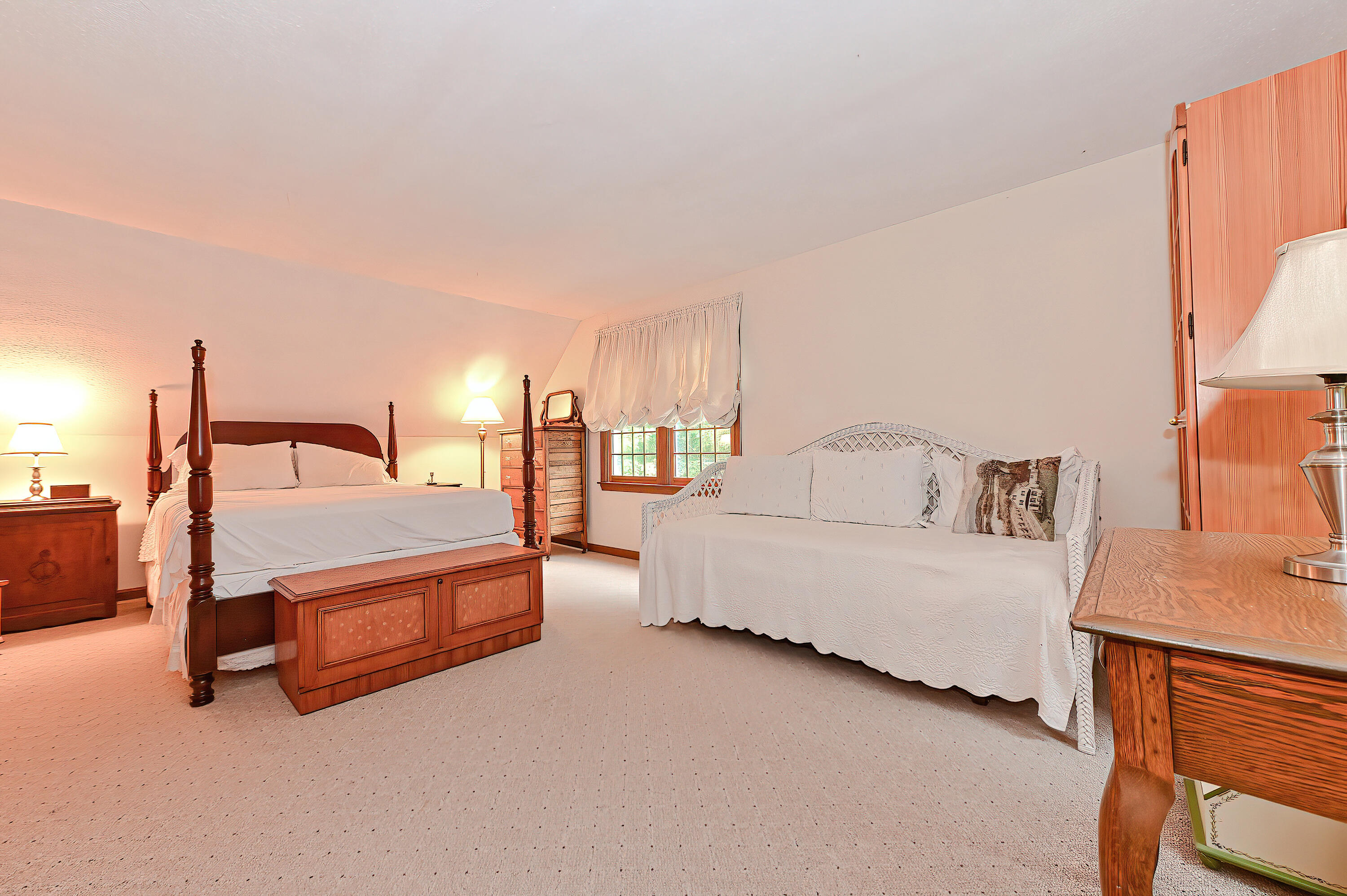 60 Grove Road Eastham, MA 02642 - Photo 27 of 39 a spacious bedroom with a bed and a lamp with the dresser