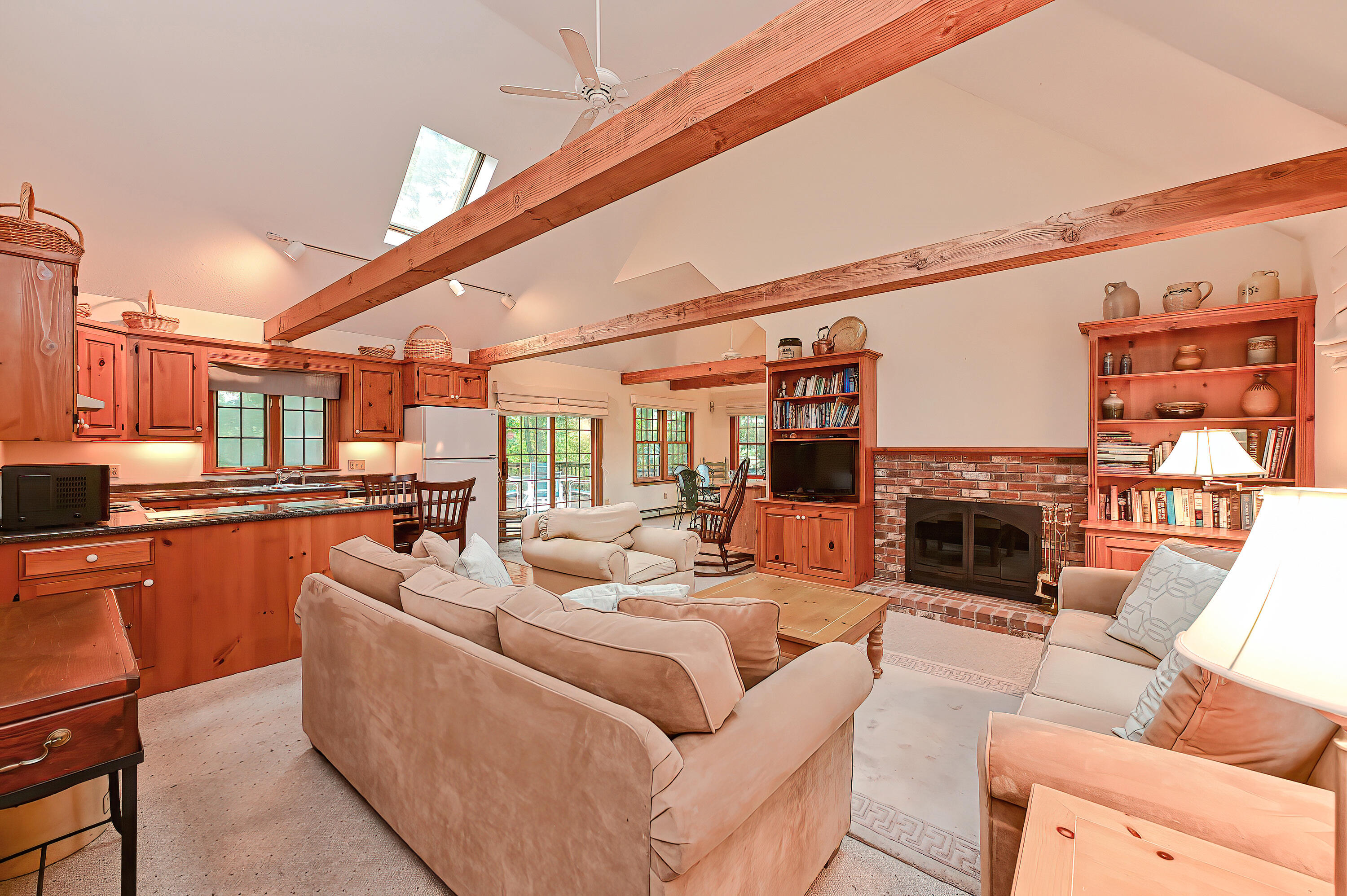 60 Grove Road Eastham, MA 02642 - Photo 8 of 39 a living room with furniture a fireplace and a flat screen tv
