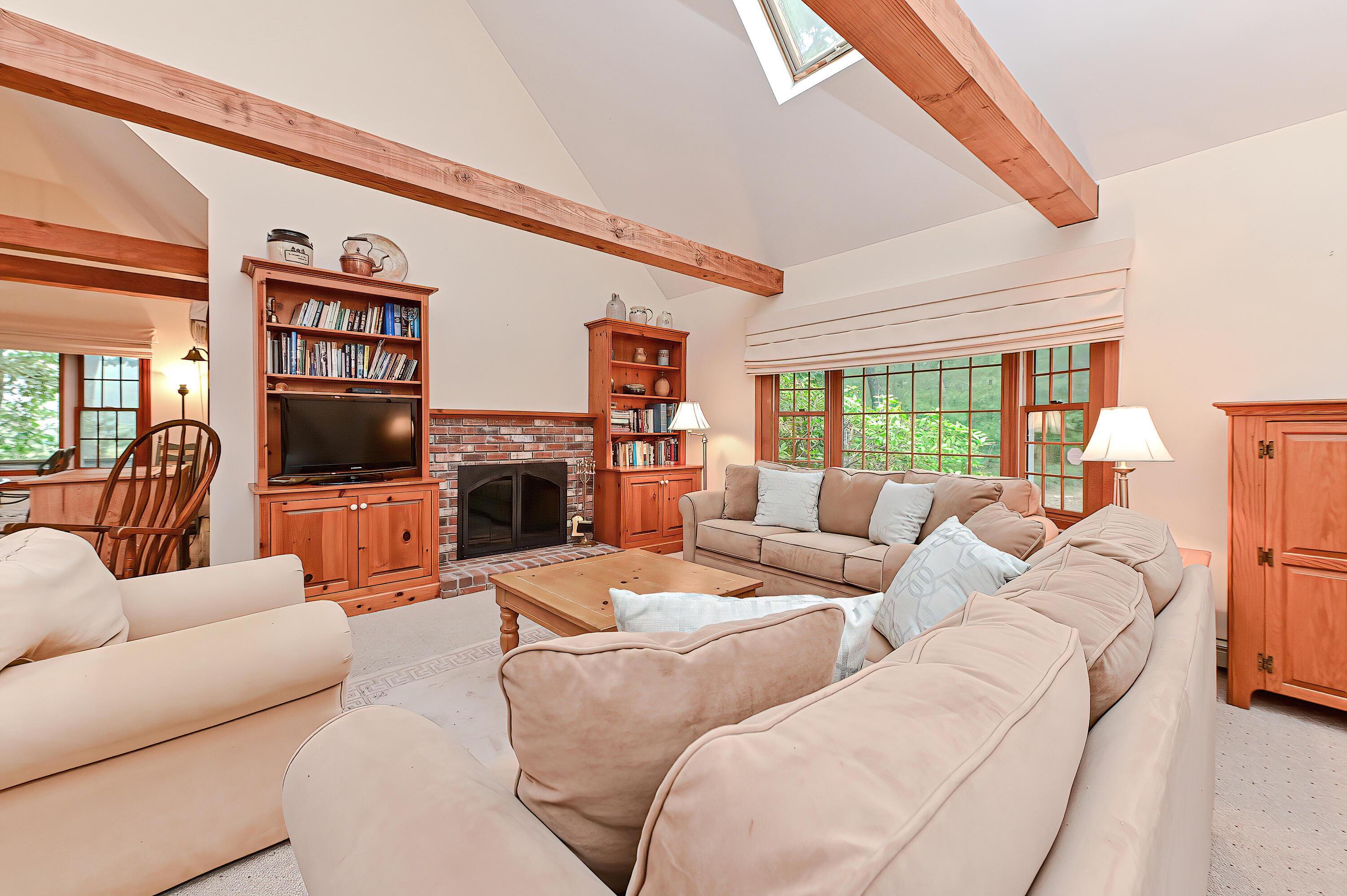 60 Grove Road Eastham, MA 02642 - Photo 9 of 39 a living room with furniture a flat screen tv and a fireplace