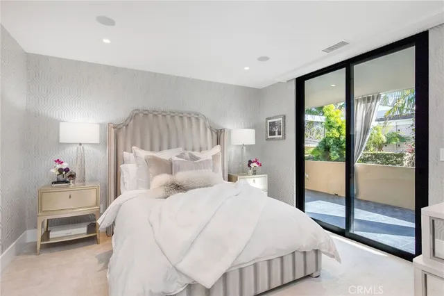 a bedroom with a bed and a large window