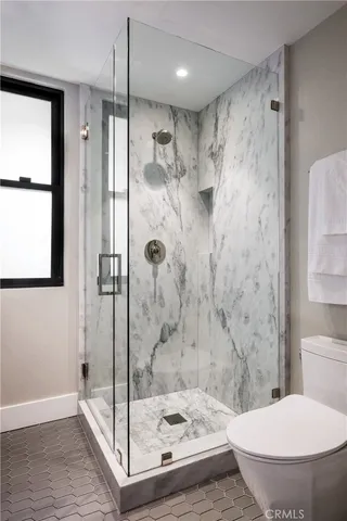 a bathroom with a toilet and a shower