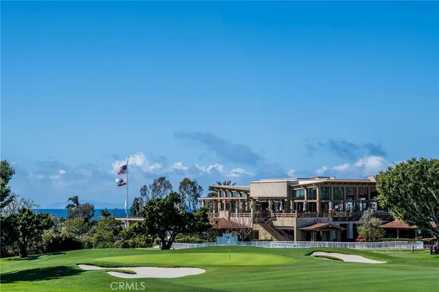 a front view of a house with a garden and trees