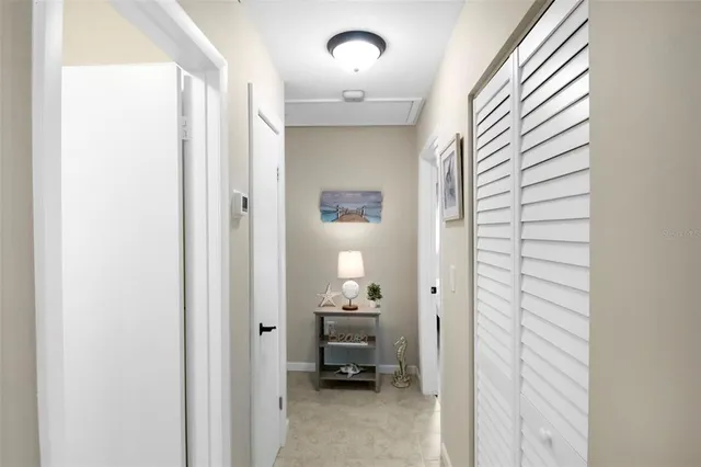 a view of a hallway and a livingroom with furniture