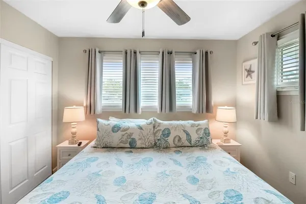 a spacious bedroom with a large bed and a chandelier