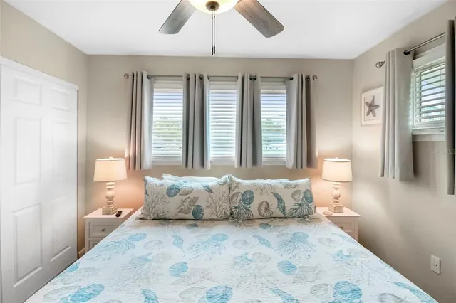 a spacious bedroom with a large bed and a chandelier