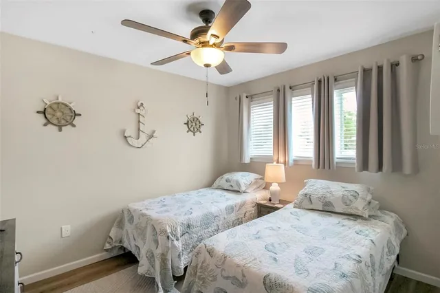 a bedroom with two beds and a window