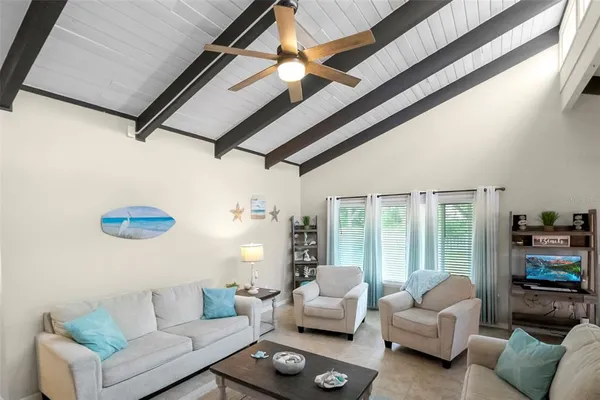 a view of a livingroom with furniture and flat screen tv