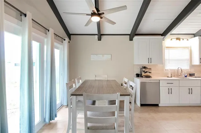 a kitchen with stainless steel appliances a stove a sink and a refrigerator