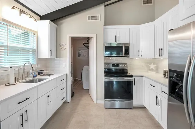 a kitchen with a sink cabinets and window
