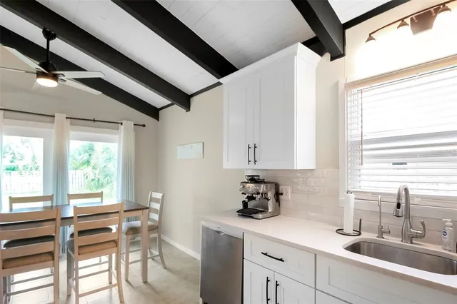 a kitchen with a sink and a stove top oven