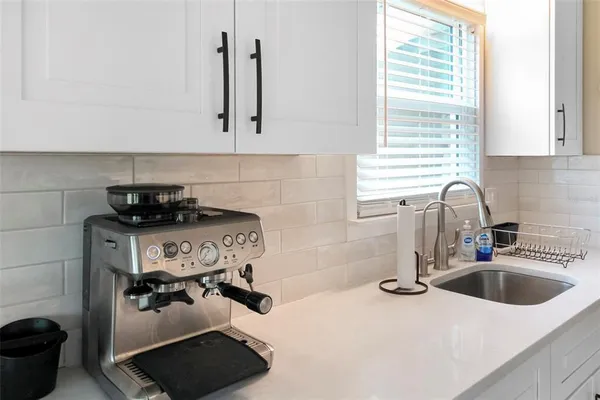 a kitchen with cabinets stainless steel appliances and a sink