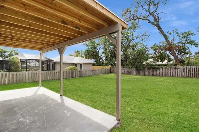 a view of a backyard with plants and a backyard