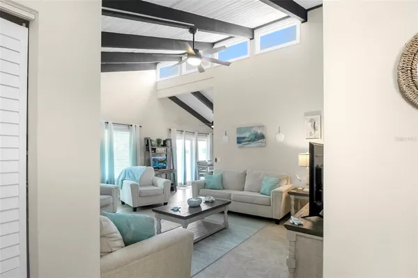 a living room with furniture and a ceiling fan